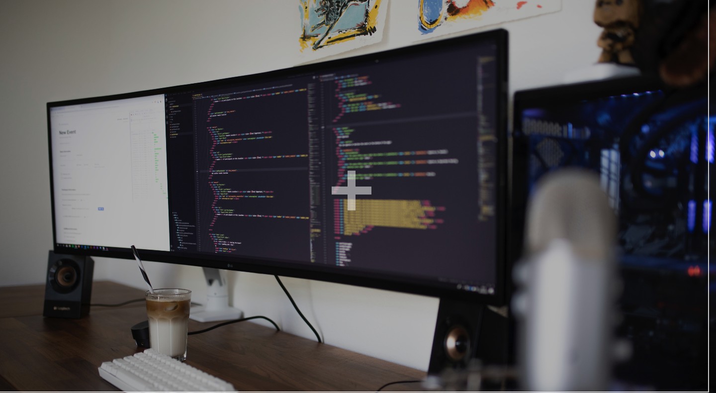 A large computer screen on a desk is split into three different panels