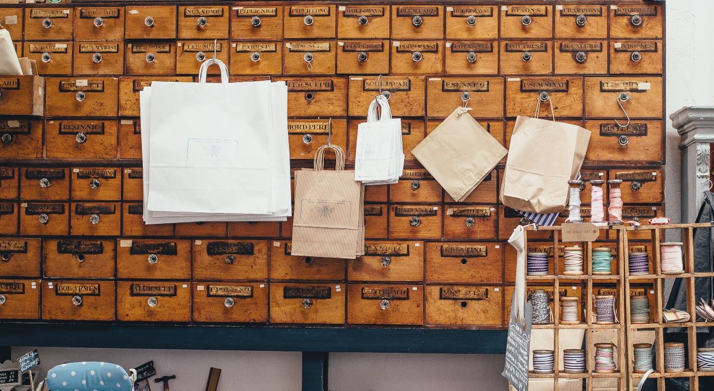 Vintage apothecary storage drawers with paper bags and twine